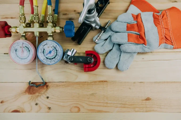 Essential HVAC tools—gauges, pipe cutter, gloves, and fittings—ready for fast, honest 24/7 service from All Hours Air experts.