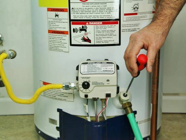 An expert technician swiftly adjusts a water heater component, highlighting our 24/7 service, honest pricing, and quality solutions.