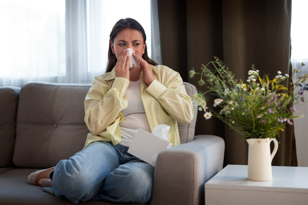 A woman sits on a couch with tissues, clearly in need of comfort—All Hours Air provides fast, 24/7 HVAC solutions you can trust.